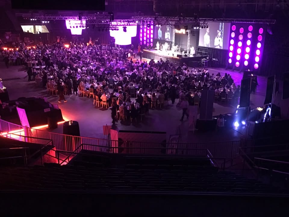 A live event with lighting and video displays